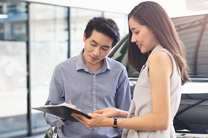 Image of dealer signing forms