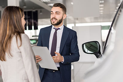 Image of dealer talking to a woman