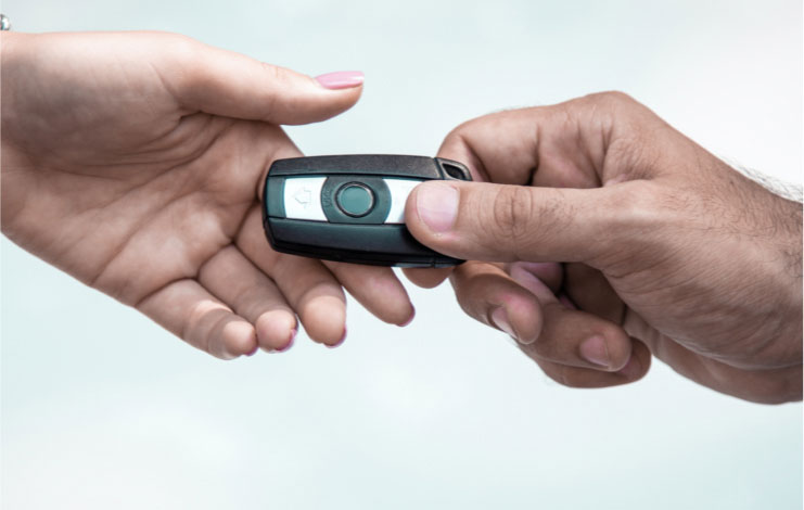 Image of person handing over a key fob.