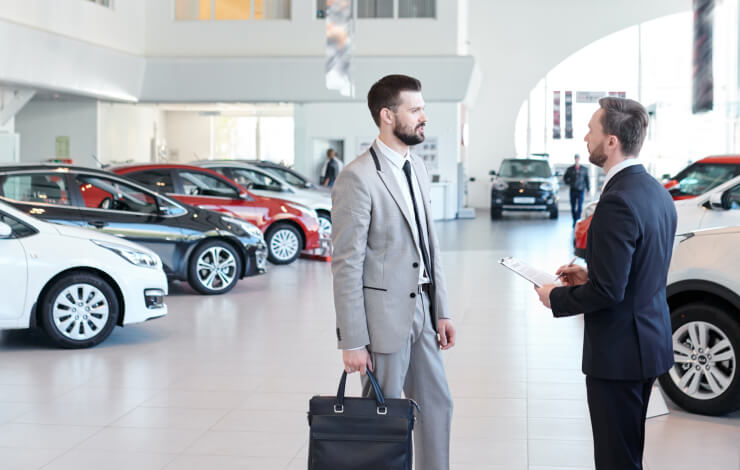 Image of two people having conversation in dealership