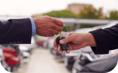 Image of two hands passing of a key.