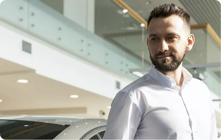 Car dealer walking on showroom floor.